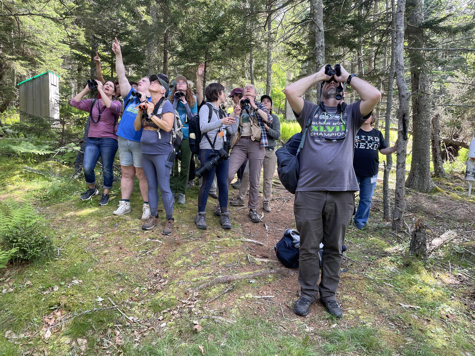 Birders pointing with binoculars